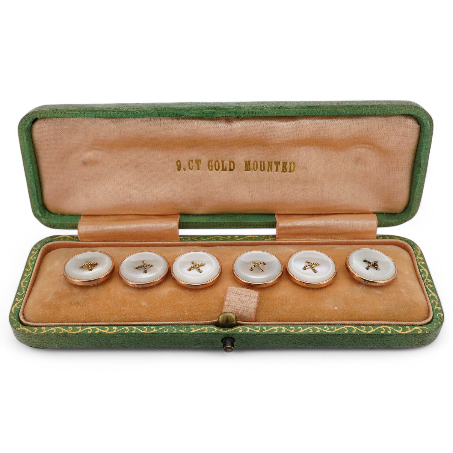 A set of six 9ct mounted mother of pearl dress studs, in a fitted gilt tooled leather case. Condition - fair to good